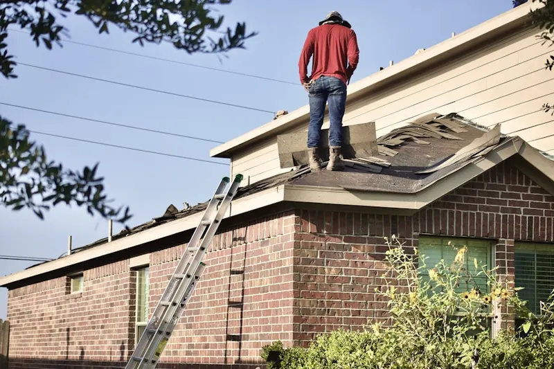 Professional roofer working on a residential roof in Bermuda Dunes